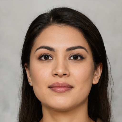 Joyful latino young-adult female with long  brown hair and brown eyes