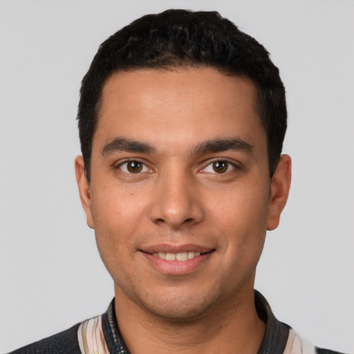 Joyful white young-adult male with short  black hair and brown eyes