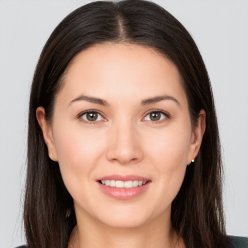 Joyful white young-adult female with long  brown hair and brown eyes