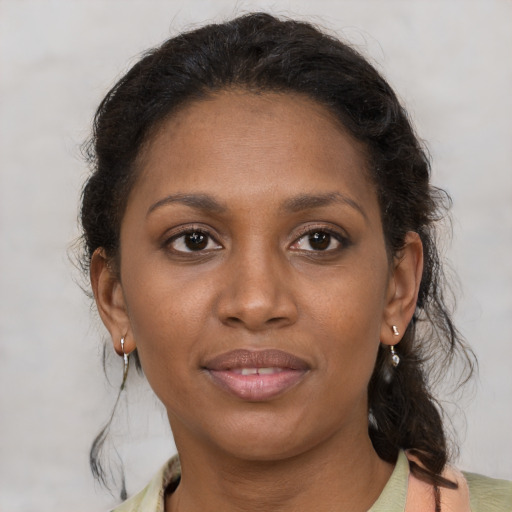 Joyful black young-adult female with medium  brown hair and brown eyes