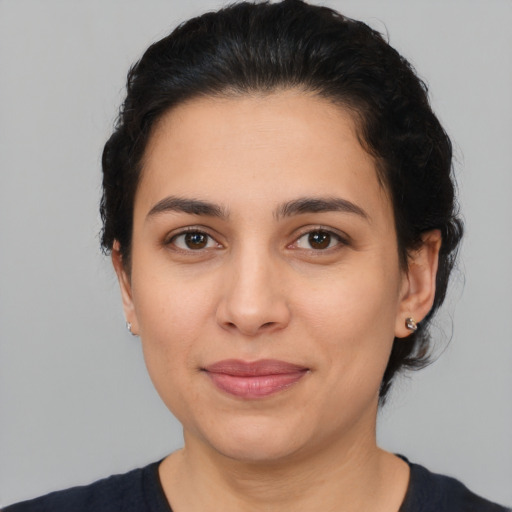 Joyful latino young-adult female with medium  brown hair and brown eyes