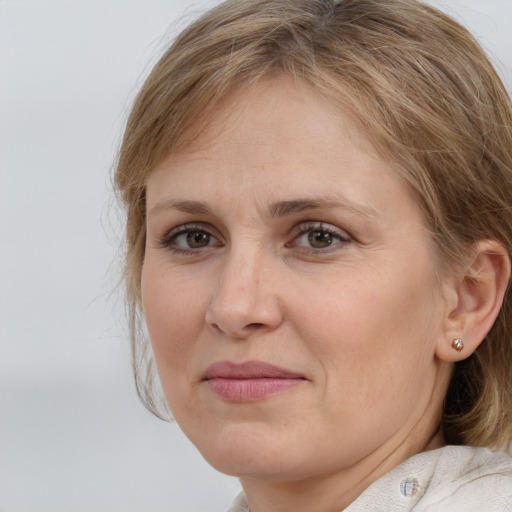 Joyful white adult female with medium  brown hair and grey eyes