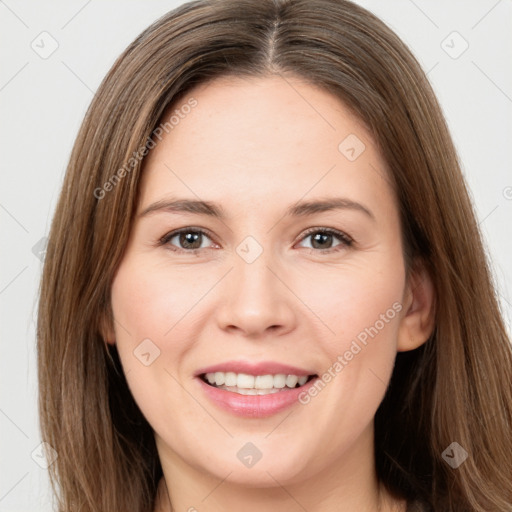 Joyful white young-adult female with long  brown hair and brown eyes