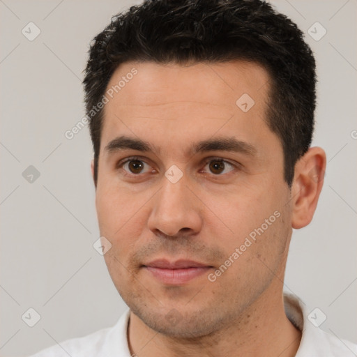 Joyful white young-adult male with short  black hair and brown eyes