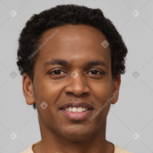 Joyful black young-adult male with short  brown hair and brown eyes