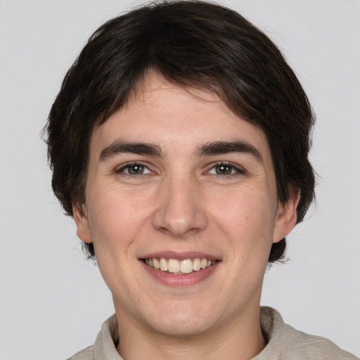 Joyful white young-adult male with medium  brown hair and brown eyes