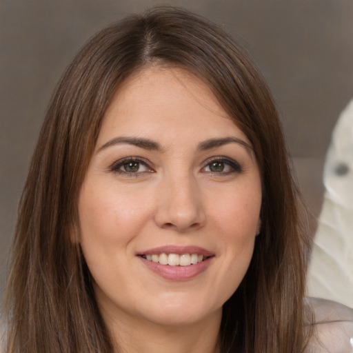 Joyful white young-adult female with long  brown hair and brown eyes