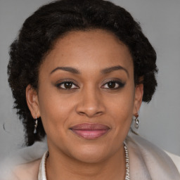 Joyful black young-adult female with short  brown hair and brown eyes