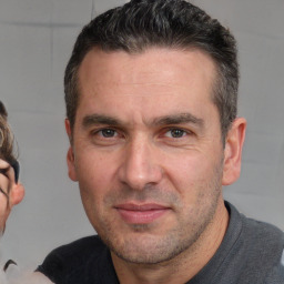 Joyful white adult male with short  brown hair and brown eyes