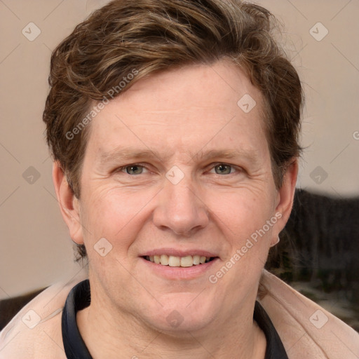 Joyful white adult male with short  brown hair and grey eyes