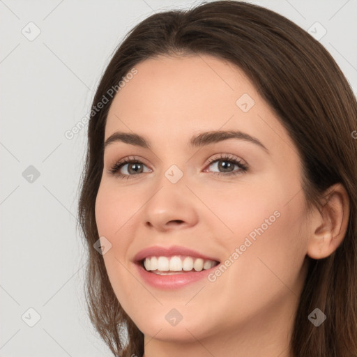 Joyful white young-adult female with long  brown hair and brown eyes