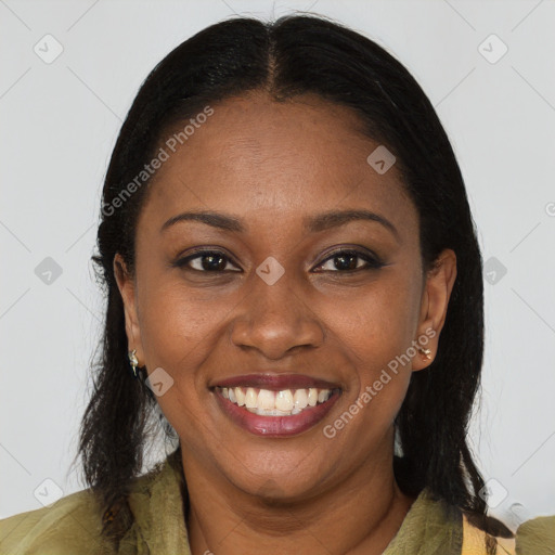 Joyful black young-adult female with long  brown hair and brown eyes