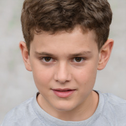 Joyful white child male with short  brown hair and brown eyes