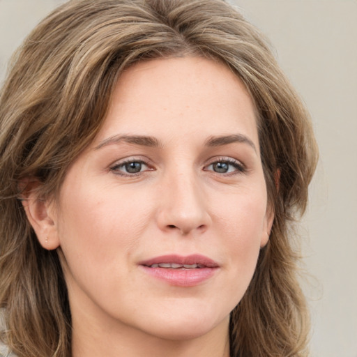 Joyful white young-adult female with medium  brown hair and green eyes