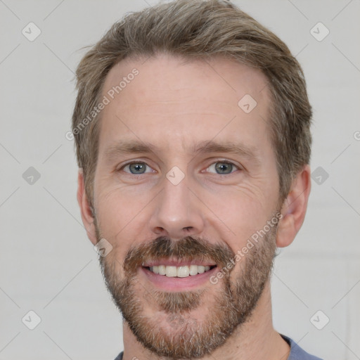 Joyful white adult male with short  brown hair and grey eyes