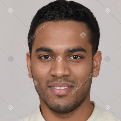 Joyful black young-adult male with short  black hair and brown eyes