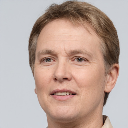 Joyful white adult male with short  brown hair and grey eyes