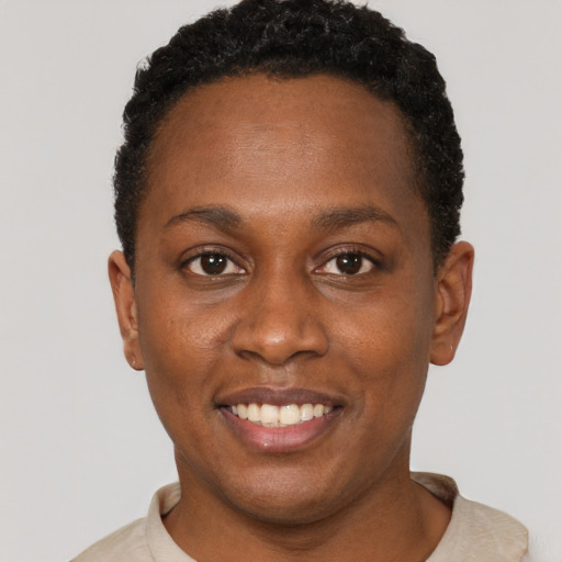 Joyful black young-adult female with short  brown hair and brown eyes