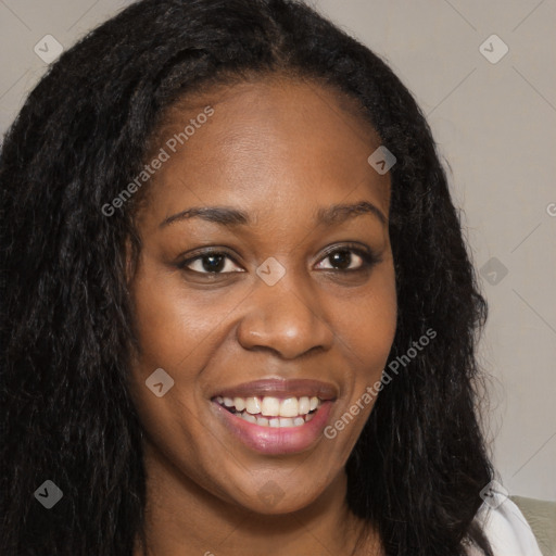 Joyful black young-adult female with long  brown hair and brown eyes