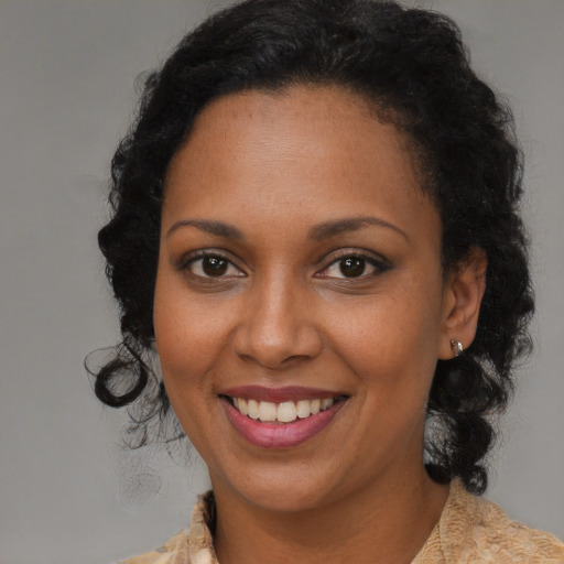 Joyful black young-adult female with medium  brown hair and brown eyes