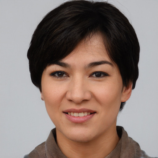 Joyful asian young-adult female with short  brown hair and brown eyes