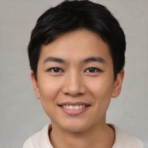 Joyful asian young-adult male with short  brown hair and brown eyes