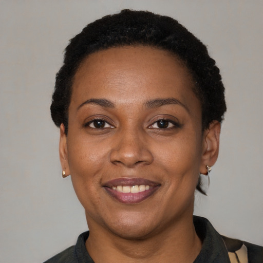 Joyful black adult female with short  brown hair and brown eyes