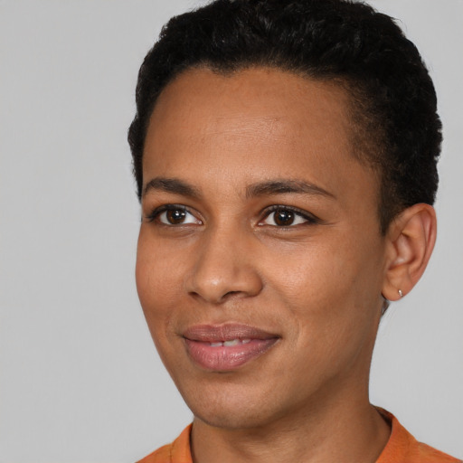 Joyful black young-adult female with short  black hair and brown eyes