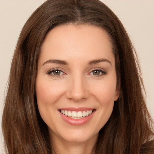 Joyful white young-adult female with long  brown hair and brown eyes