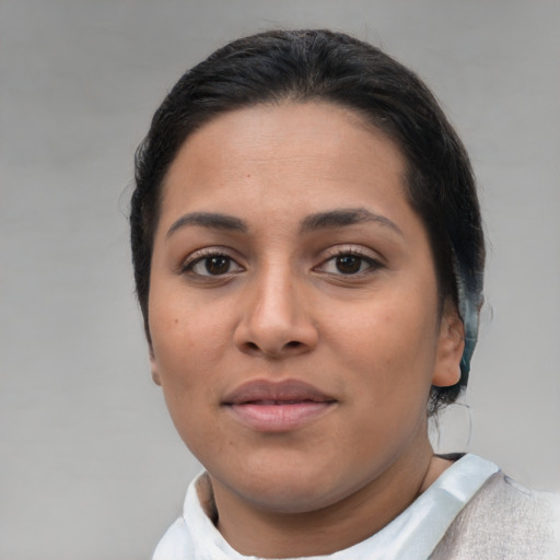 Joyful latino young-adult female with short  brown hair and brown eyes