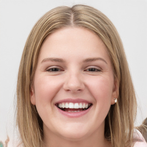 Joyful white young-adult female with medium  brown hair and green eyes