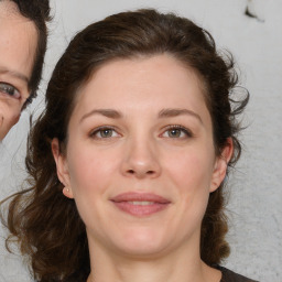 Joyful white adult female with medium  brown hair and brown eyes