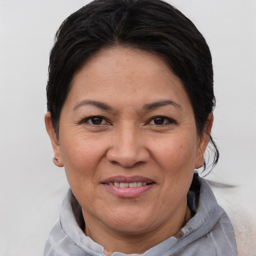 Joyful white adult female with short  brown hair and brown eyes