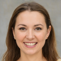 Joyful white young-adult female with medium  brown hair and green eyes