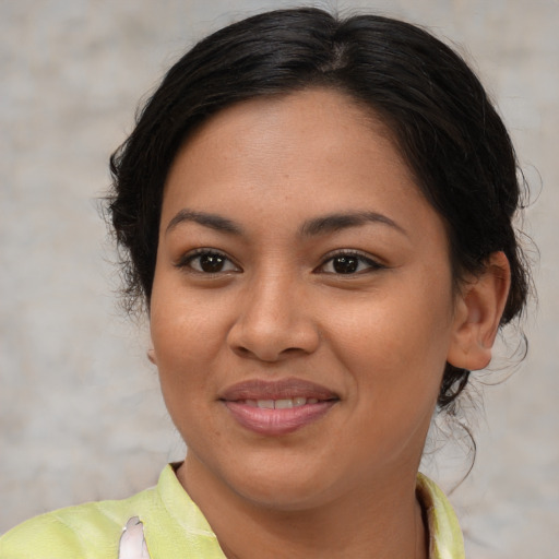 Joyful latino young-adult female with medium  brown hair and brown eyes