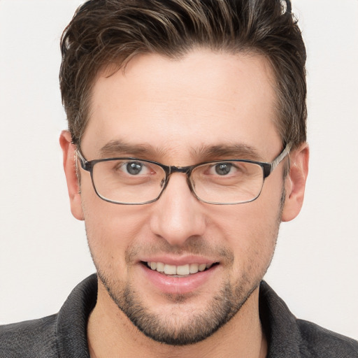 Joyful white adult male with short  brown hair and grey eyes