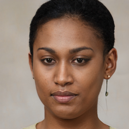 Joyful black young-adult female with short  brown hair and brown eyes