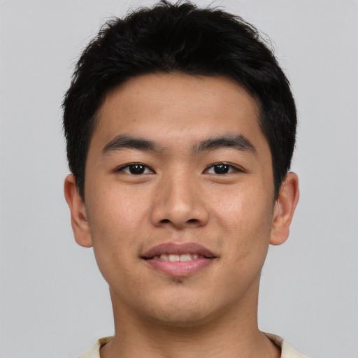 Joyful asian young-adult male with short  black hair and brown eyes