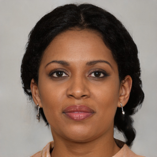 Joyful black young-adult female with medium  brown hair and brown eyes