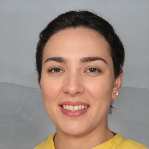 Joyful white young-adult female with short  black hair and brown eyes