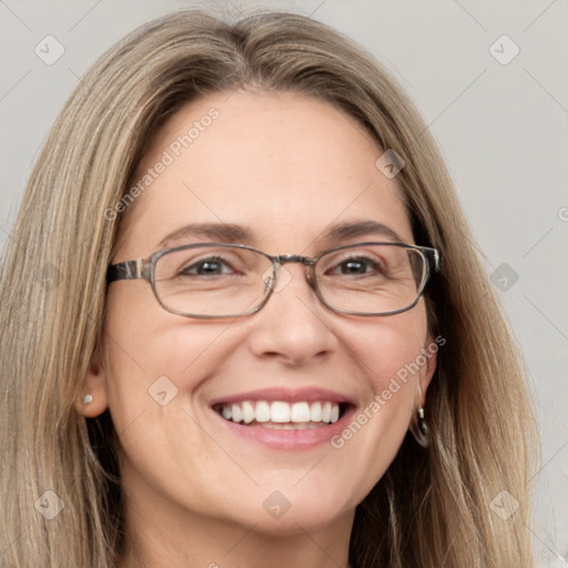 Joyful white adult female with long  brown hair and blue eyes