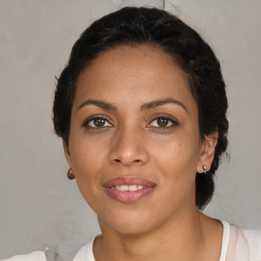 Joyful latino young-adult female with short  black hair and brown eyes