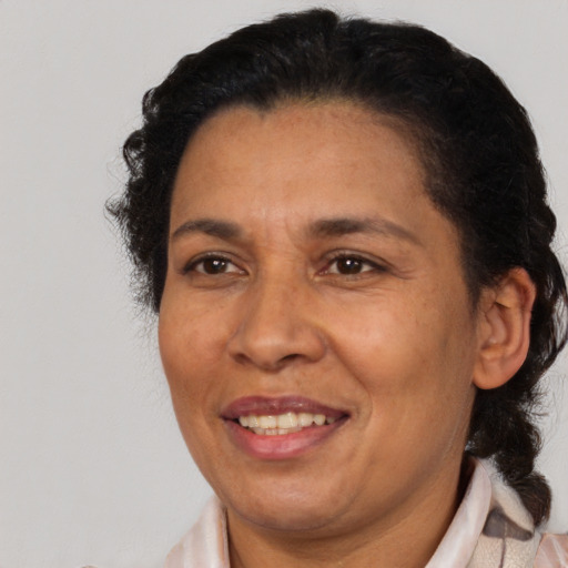 Joyful latino adult female with short  brown hair and brown eyes
