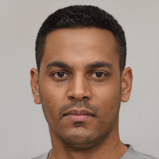 Neutral latino young-adult male with short  black hair and brown eyes
