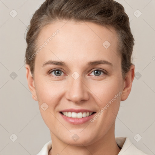 Joyful white young-adult female with short  brown hair and grey eyes