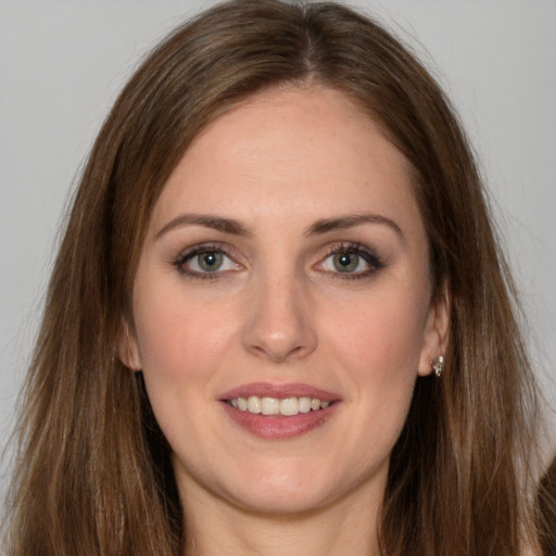 Joyful white young-adult female with long  brown hair and green eyes