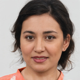 Joyful white young-adult female with medium  brown hair and brown eyes