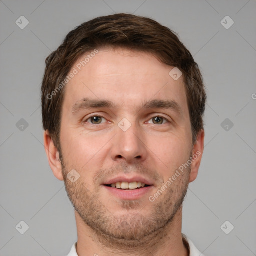 Joyful white young-adult male with short  brown hair and grey eyes