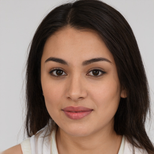 Joyful latino young-adult female with medium  brown hair and brown eyes