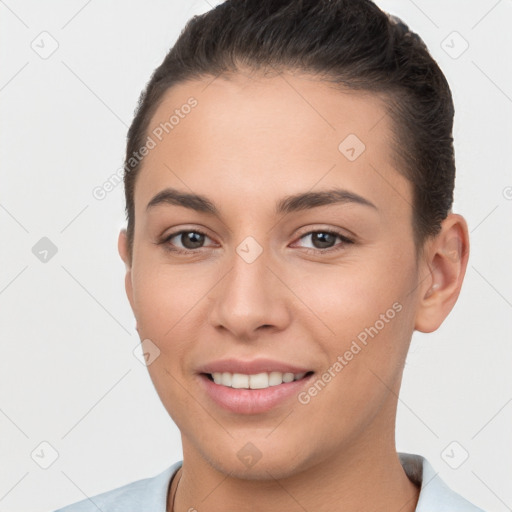 Joyful white young-adult female with short  brown hair and brown eyes